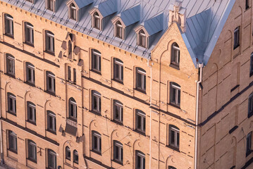 Facade of a multi-story residential building constructed in the 1920s–1930s, beautifully restored. Classic architectural details preserved, giving the building a charming and elegant appearance.