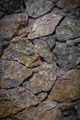 Vertical warm mixed stone wall background