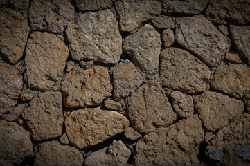 Warm beige natural stone wall background texture