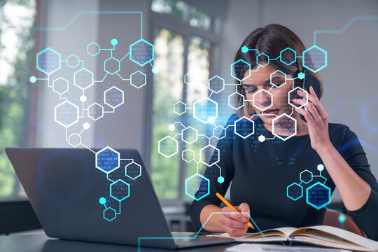 Woman multitasking with laptop and notes, overlay of digital hexagons and binary code, technology and data concept on office background.