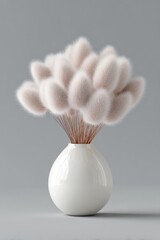 Elegant white vase holding soft fluffy decorative flowers on gray background