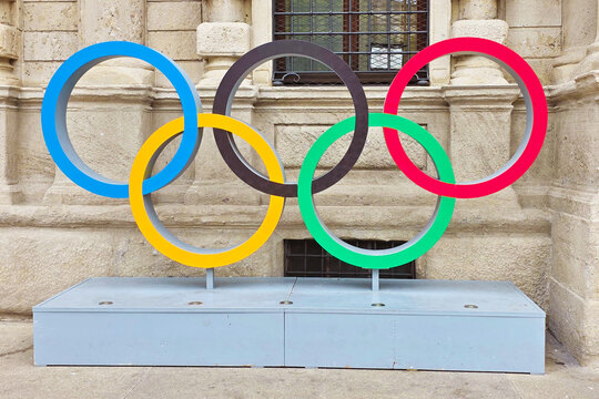 Milan, Italy - August 06, 2025: Milano Cortina 2026 Olympic games winter sport - Winter Olympics symbol logo circles in Piazza Della Scala downtown of the city