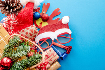 Christmas motif featuring wrapped gifts, decorative wreath, red ribbon, pine cone, on a bright red background. Conceptual image for festive advertising and winter celebrations