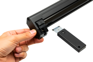 Hand inserting a new sharp blade into a window scraper tool on a transparent background