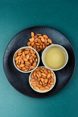 Almond oil with shelled almond nuts.