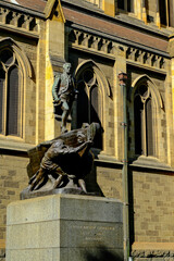 A historic statue stands in front of the gothic-style St Paul’s Cathedral in Melbourne.
