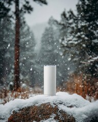 White Portable Speaker on Rocky Surface Amidst Snowy Wilderness