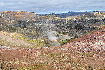 View from the volcano to the lava field, colorful mountains