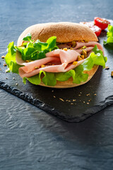 Sandwich with mortadella and pistachios on wooden table	