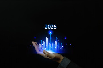 Business hand holding glowing digital growth chart with rising bars and arrows, symbolizing future...