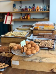 Assorted baked goods displayed in a cozy bakery shop with wooden interior