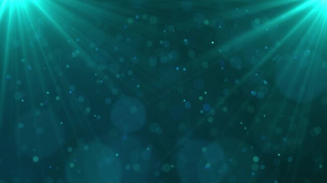Abstract teal background with light rays and bokeh effect.