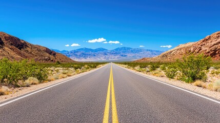 Fototapeta premium Scenic Desert Road Stretched Through Breathtaking Mountain Landscape Under Clear Blue Sky