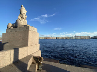 Sphinx statue on the Neva River on University embankment in Saint Petersburg, Russia, with cityscape in the distance
