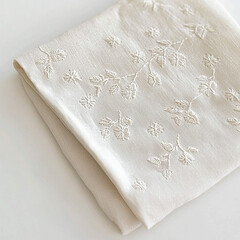 Minimalist soft linen fabric with white embroidery. Elegant background napkin for product mockups.