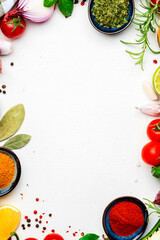 Healthy cooking food background with spices, herbs, turmeric, dried herbs, chili powder and kitchen utensils, white table, top view