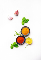 Food, cooking, spices background, ground chili pepper and turmeric, rosemary, garlic, lime, Indian and Asian cuisine ingredients, white copy space, top view
