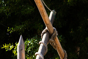 Close-up of Thick Rope Twisted Around a Wooden Post in Sunlight