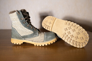 Side view of worn rustic boots made from nubuck leather and natural burlap fabric. Adventure and outdoor lifestyle concept