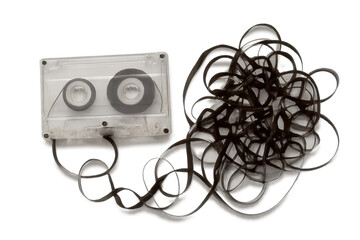 Cassette tape with tangled magnetic tape creating chaos