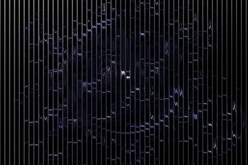 Dark, fractured glass panels behind a metal grid