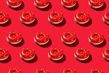 Overhead view of various donuts with confetti arranged on colored background
