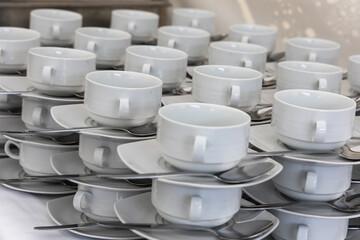 White soup cups arranged on a table for refreshments