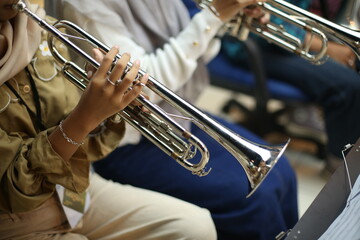 Close Up of Musician Playing Silver Trumpet on rehearsal studio 
