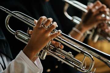 Close Up of Musician Playing Silver Trumpet on rehearsal studio 