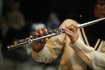 Close Up hands of Musician Playing flute in the rehearsal studio