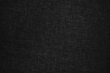 Dark black fabric texture background with soft folds and shadows, minimalist backdrop for design, presentation, advertising, and modern graphic projects.