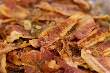 pile of thick cut bacon on a griddle in a restaurant