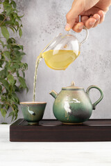 Teapot pouring green tea, tea ceremony. 
