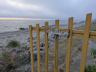 View of a private beach that was fenced off with a private sign early in the morning