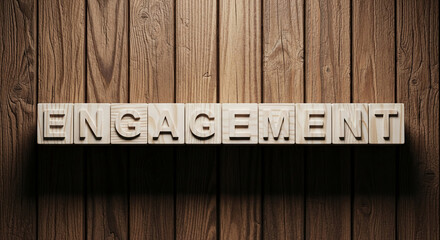 Wooden blocks spelling "Engagement" on brown wood background Free space below for text or logo Ideal for business, marketing, or social media concepts