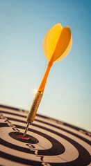 Close-up of yellow dart in bullseye, against a clear blue sky, representing success, achievement, and target accomplishment in business