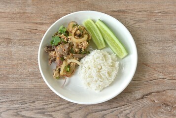 boiled chop pork with liver Thai salad taste spicy and sour on plate eat coupl rice and fresh cucumber