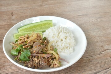 boiled chop pork with liver Thai salad taste spicy and sour on plate eat coupl rice and fresh cucumber