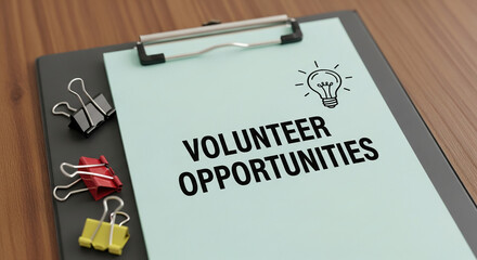 Clipboard with light green paper, displaying "Volunteer Opportunities" and a light bulb drawing, representing collaboration and community contribution