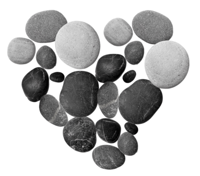 heart shape formed by smooth black and grey pebbles on a dark background