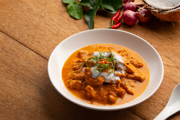 Panaeng Curry with pork.Sliced pork Meat in red curry paste and coconut milk,topping with coconut cream and Shredded kaffir lime leaves.Thai style food.