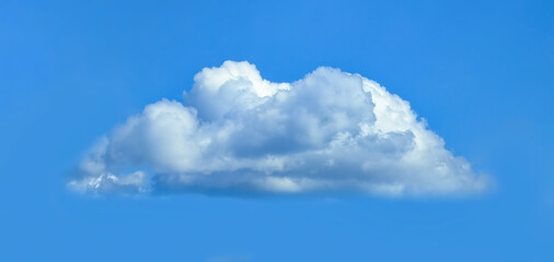 Low angle view of fluffy cumulus clouds against blue sky background.