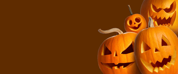 Halloween poster design. Pumpkins with carved spooky faces peeking out against brown background. Space for text