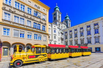 Linz, Austria. Old Cathedral (Alter Dom) and tourist train in the Main Square (Hauptplatz)
