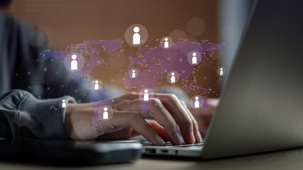 Digital workforce concept with hands typing on laptop and global network icons, symbolizing remote work, virtual collaboration, human resources technology, and global business connectivity.