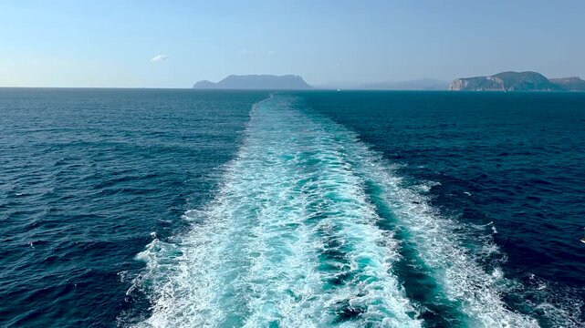 foam trail from a passenger ship sailing in summer
