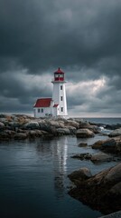 Classic lighthouse against stormy sky on rocky coastline at dusk
