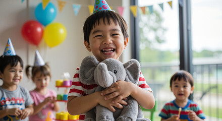 Birthday boy holding stuffed animal with friends and colorful decorations