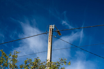 Led street light on electricity post , dark blue sky with white clouds background.