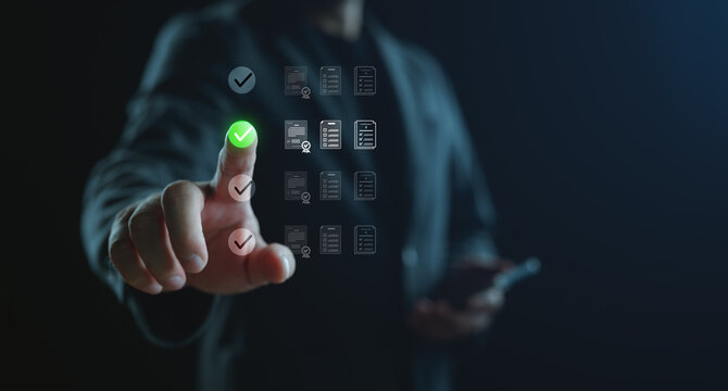 Businessman touching virtual checklist interface with green tick mark, representing task management, decision making, quality control, and digital approval process in modern business.